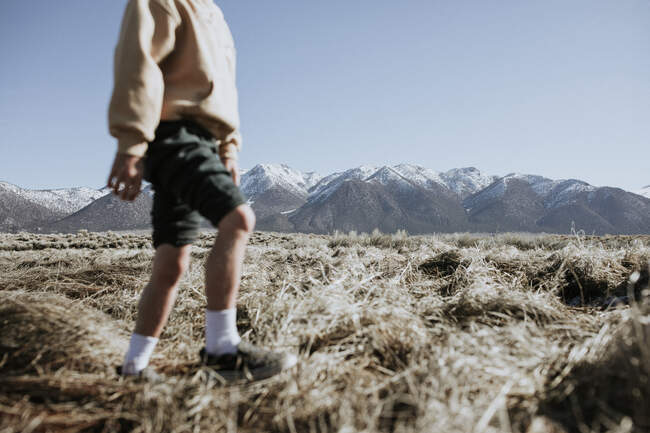 Boy walking through rural landscape, California, USA — Stock Photo