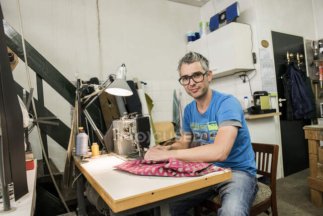 Portrait of male Carpenter sewing fabric — Stock Photo