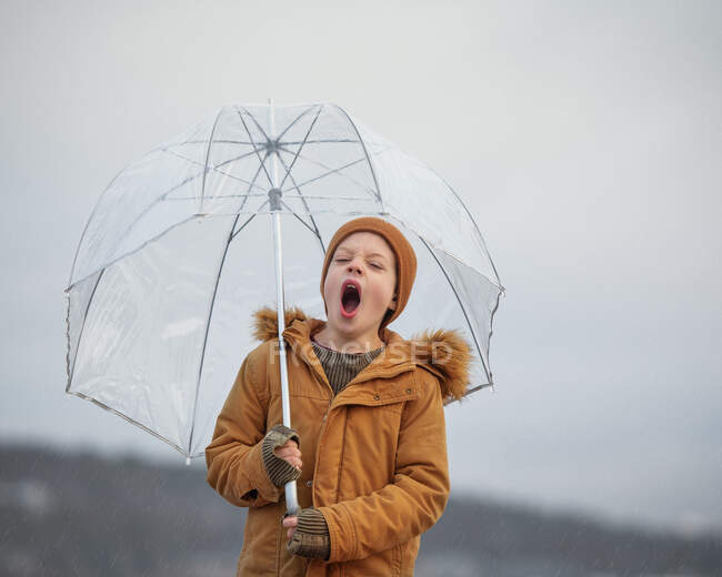 Menino segurando um guarda-chuva bocejando, Bedford, Nova Escócia, Canadá — Fotografia de Stock
