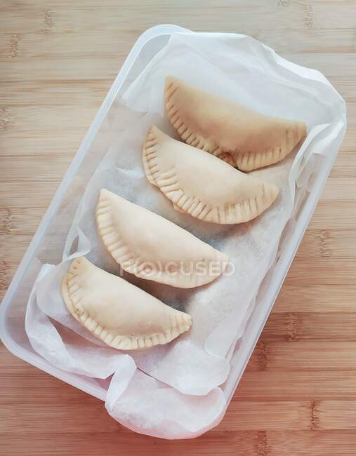 Plastic container filled with home made dumplings — Stock Photo
