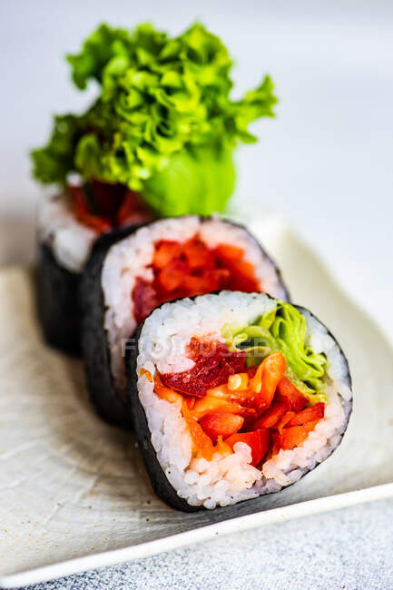 Set di sushi con futo maki servito su tavolo in pietra con bacchette — Foto stock