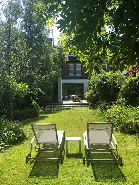 Sun loungers in a garden, London, England, UK — Stock Photo