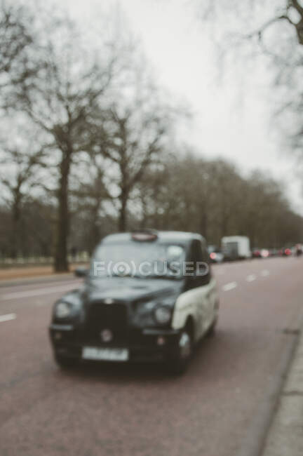 London taxi driving through the city, London, UK — Stock Photo