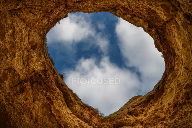 Veduta di un cielo nuvoloso attraverso un buco nelle rocce, Portogallo — Foto stock