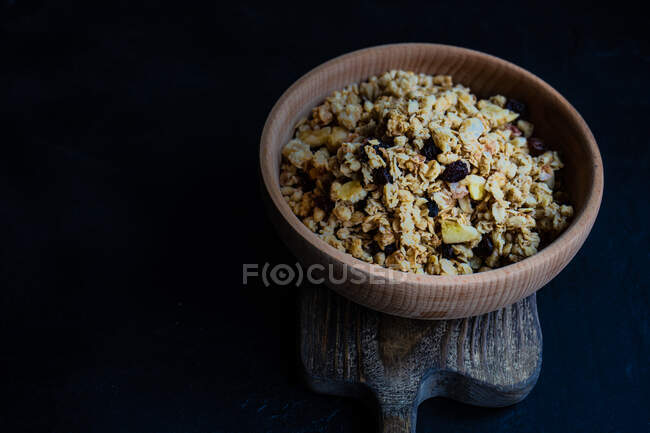 Bowl of granola on a chopping board — Stock Photo
