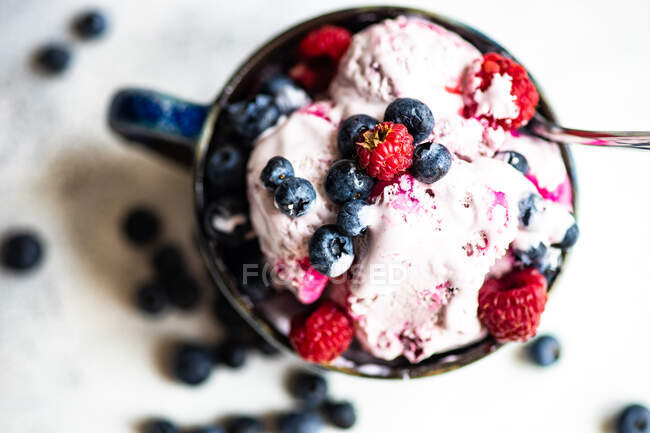 Ice cream with blueberries and berries on white background — Stock Photo