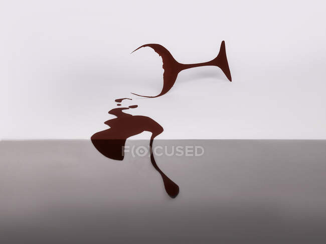 Conceptual red wine glass with spilled wine — Stock Photo