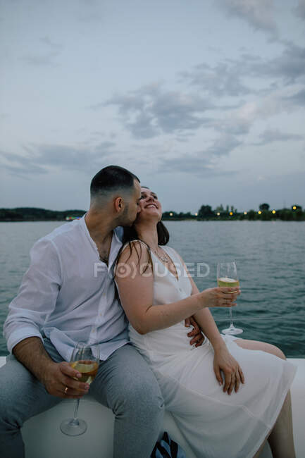 Happy couple sitting on a yacht kissing, Russia — Stock Photo