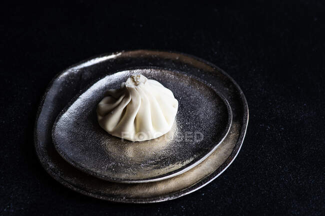 Traditional Georgian khinkali dumpling on a metal dish — Stock Photo
