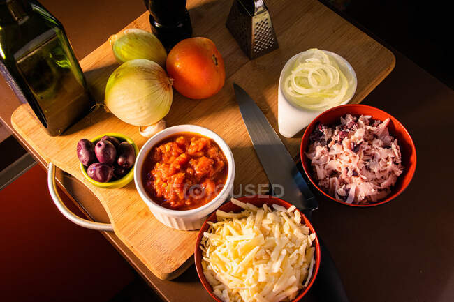 Bowls of pizza toppings in a kitchen — Stock Photo