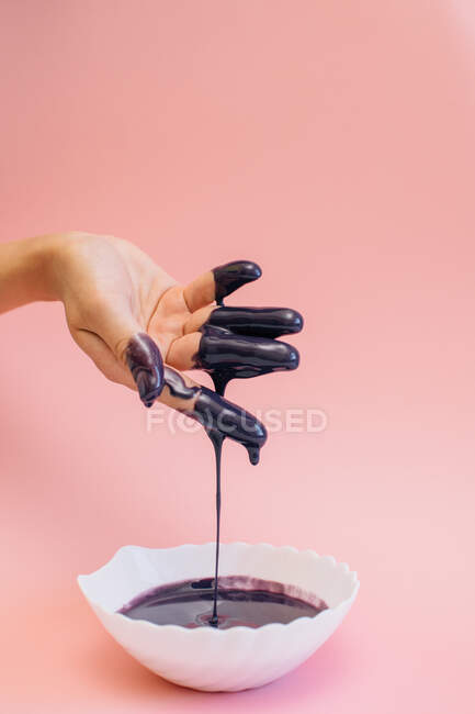 Woman's hand covered in violet glaze — Stock Photo