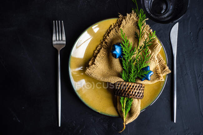 Christmas table setting for holiday dinner on black concrete background with copy space — Stock Photo