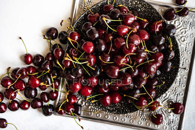 Bowl of cherries on a metal tray — Stock Photo