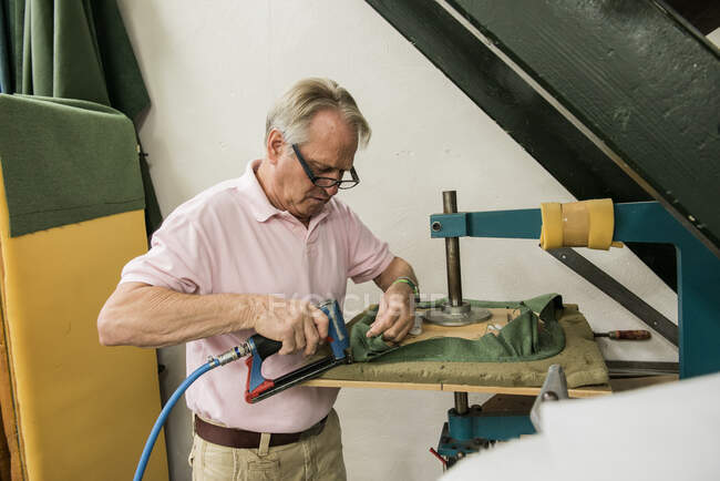 Retrato de un carpintero haciendo una silla en un taller de carpintería de muebles, Tilburg, Noord-Brabant, Países Bajos - foto de stock