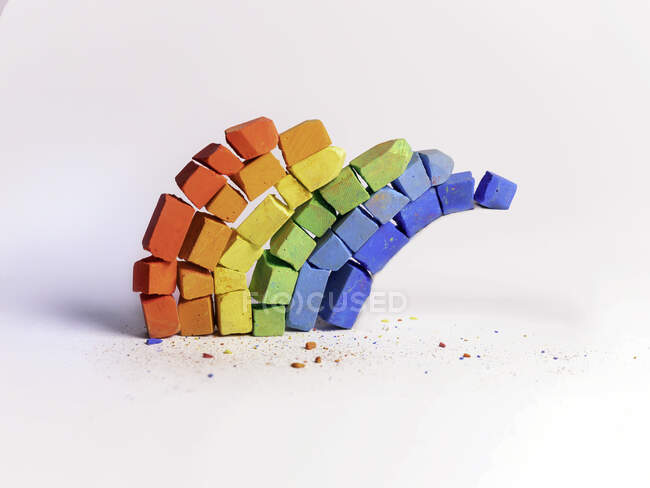 Conceptual rainbow made of various colored chalk pieces — Stock Photo