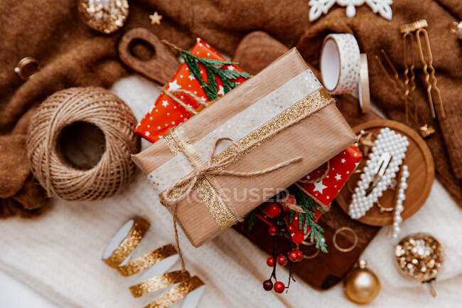 Wrapped Christmas decorations, string, ribbon and Christmas decor — Stock Photo