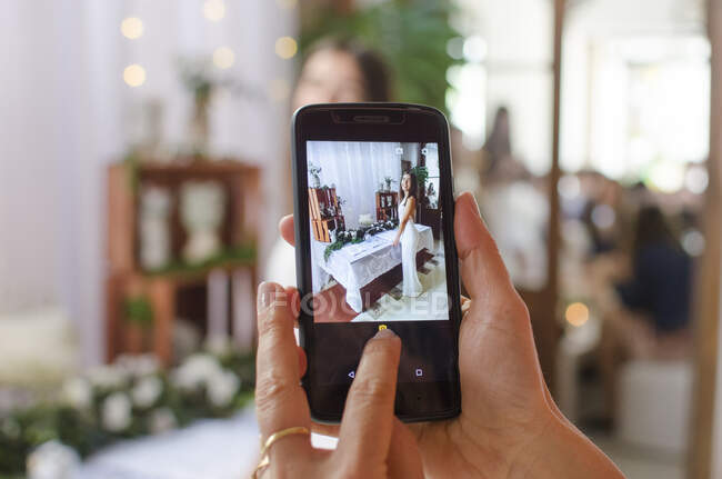 Woman photographing her daughter standing in front of a festive birthday table setting — Stock Photo