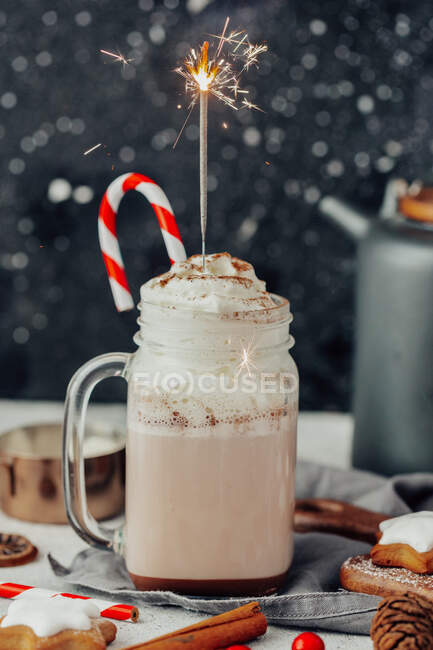 Sprinkler in a mug of hot chocolate with whipped cream — Stock Photo