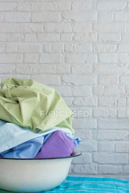 Multi coloured laundry in a bowl — Stock Photo