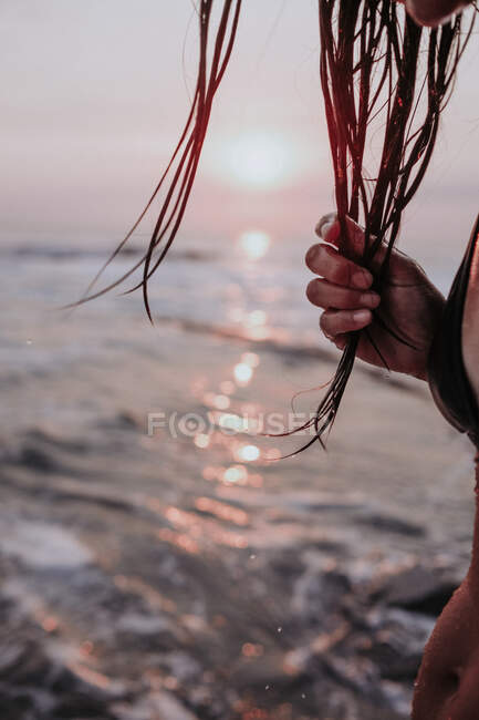 Close-up of a woman on beach with wet hair at sunset, Laguna Beach, California, USA — Stock Photo