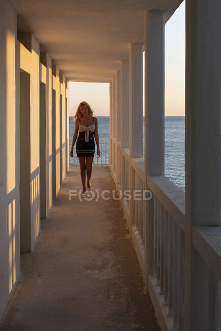 Woman walking along a corridor, Gallipoli, Puglia, Italy — Stock Photo