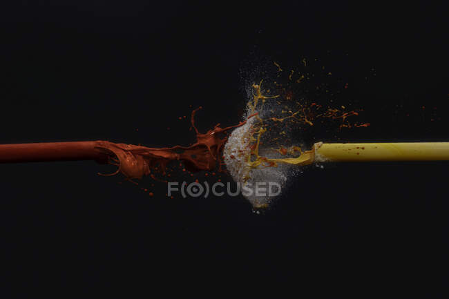 Acrylic paint being fired through a tube of compressed air — Stock Photo