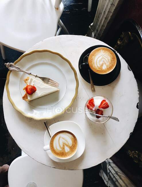 White coffee cup with cream and chocolate — Stock Photo