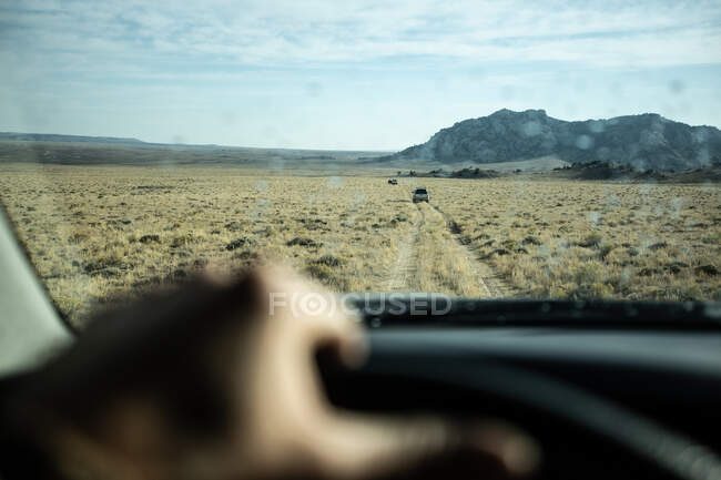 One person driving through a desert landscape, United States — Stock Photo