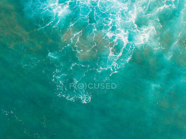 Water surface with green and white waves — Stock Photo