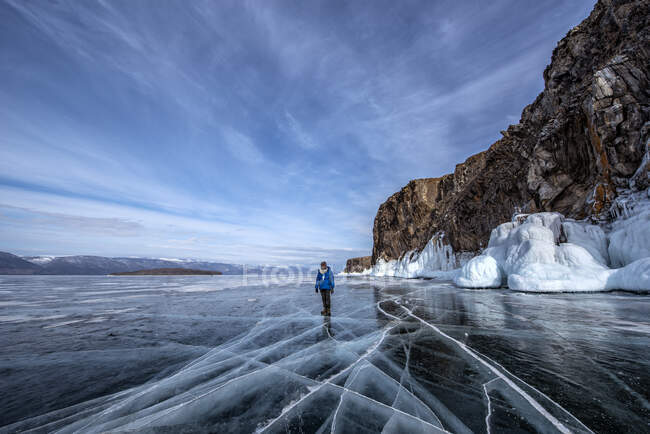 Hombre de pie en el lago congelado Baikal en invierno, Siberia, Rusia - foto de stock