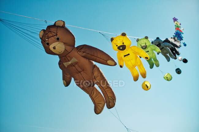 Teddy bear kites flying in sky at a kite festival, East Frisia, Lower Saxony, Germany — Stock Photo