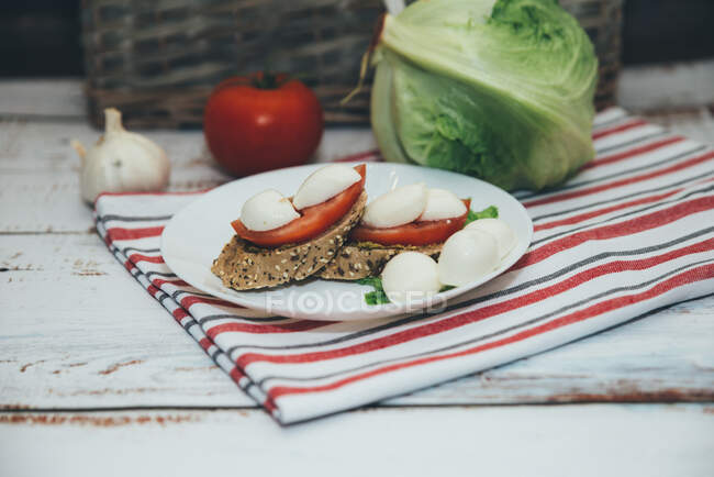 Mozzarella and tomato on bread — Stock Photo