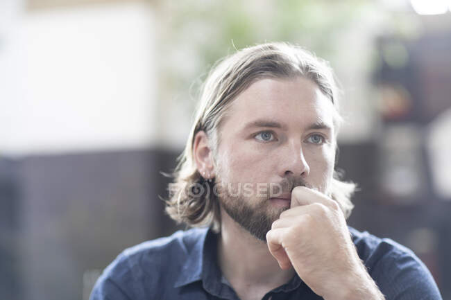 Portrait of a man with his hand on his face — Stock Photo