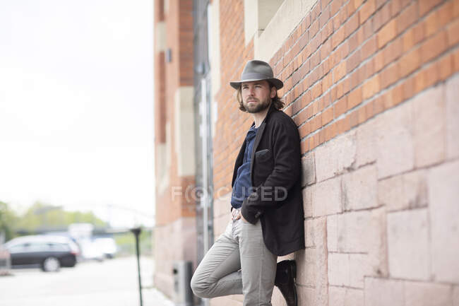 Portrait of a man leaning against a wall — Stock Photo