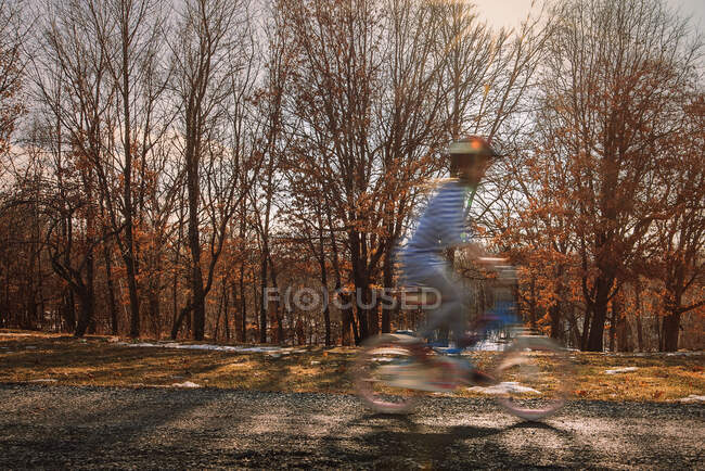 Girl riding a bicycle in the park, United States — Stock Photo