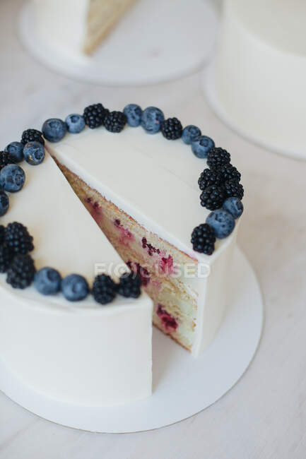 Close-up of a carrot cake with nuts, blueberries and blackberries — Stock Photo
