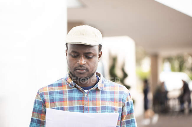 Portrait of a man holding paperwork — Stock Photo