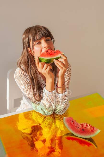 Woman eating a slice of watermelon — Stock Photo
