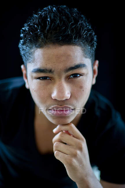 Portrait of a teenage boy on dark background — Stock Photo