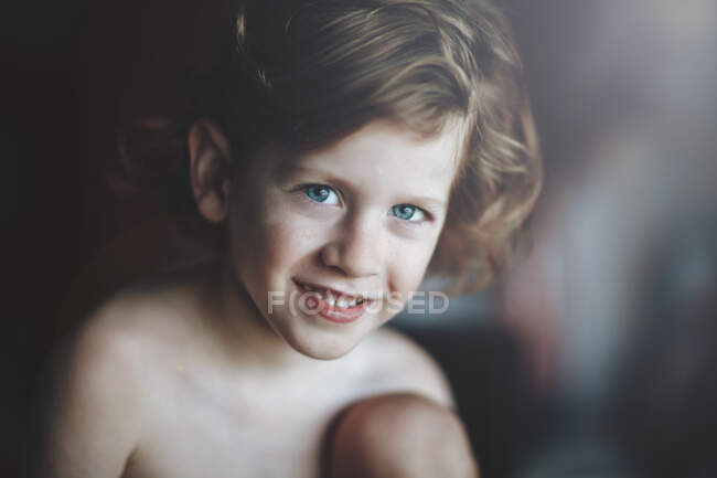 Портрет усміхненого маленького хлопчика в кімнаті — стокове фото