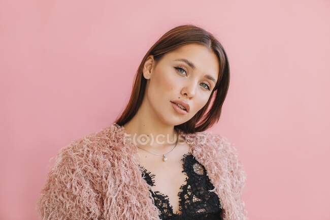 Portrait of a beautiful woman on pink background — Stock Photo