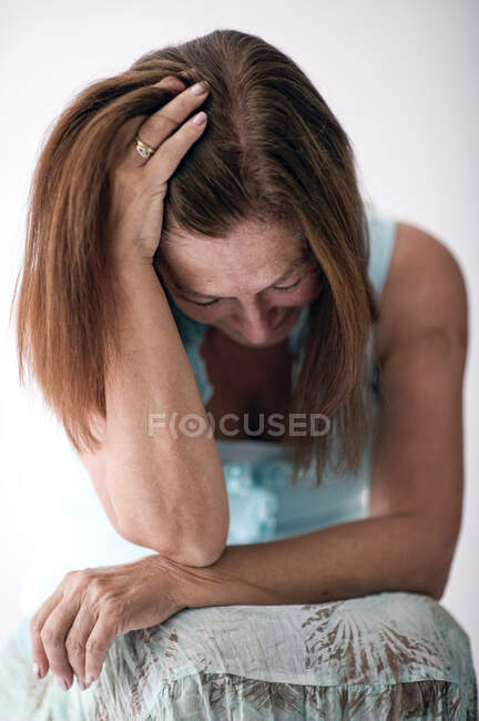 Portrait of a woman with her head in her hands — Stock Photo