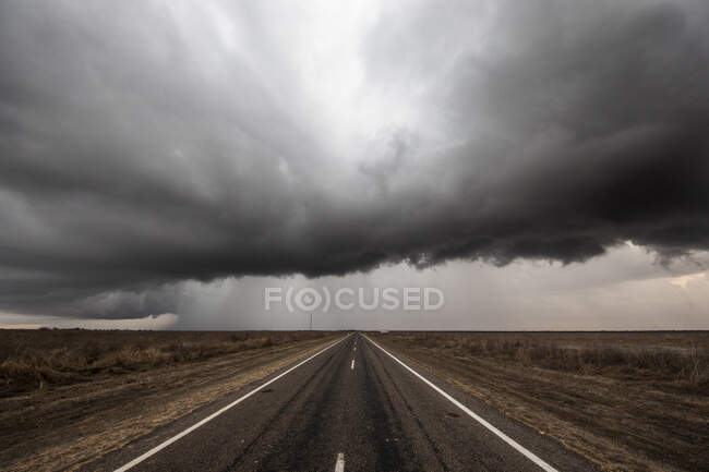 Шторм над пустой прямой дорогой, Квинсленд, Австралия — стоковое фото