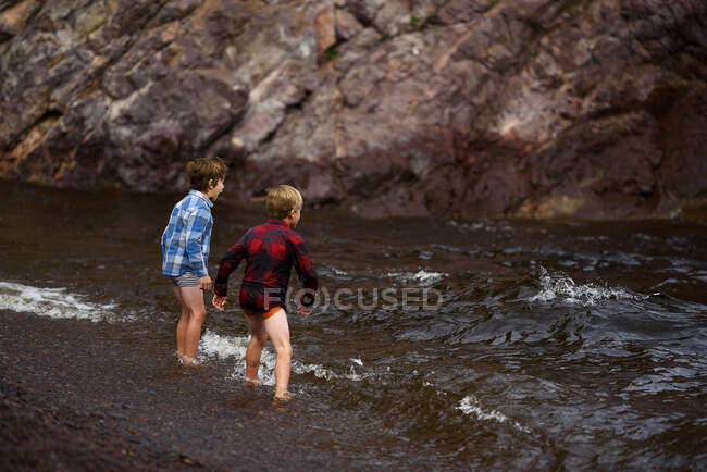 Two boys paddling in a river, United States — Stock Photo