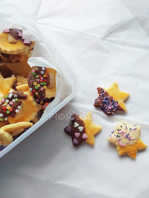 Plastic box filled with decorated cookies — Stock Photo