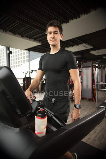 Portrait of a man on a treadmill at gym — Stock Photo