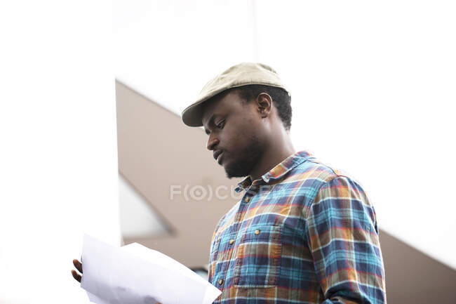 Portrait of a man standing by a truck looking at paperwork — Stock Photo