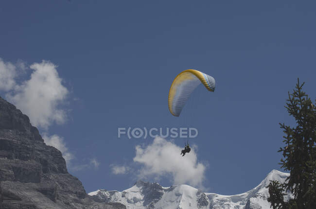 Man paragliding above mountains, Switzerland — Foto stock
