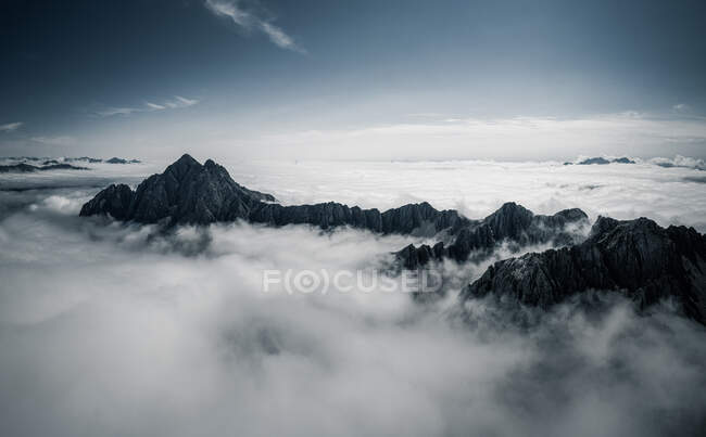 Picos de montaña sobre nubes, Dolomitas, Lienz, Austria - foto de stock