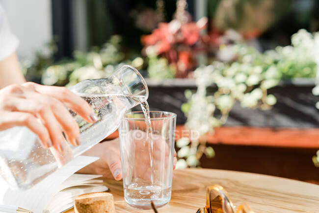 Woman pouring a glass of water — Stock Photo